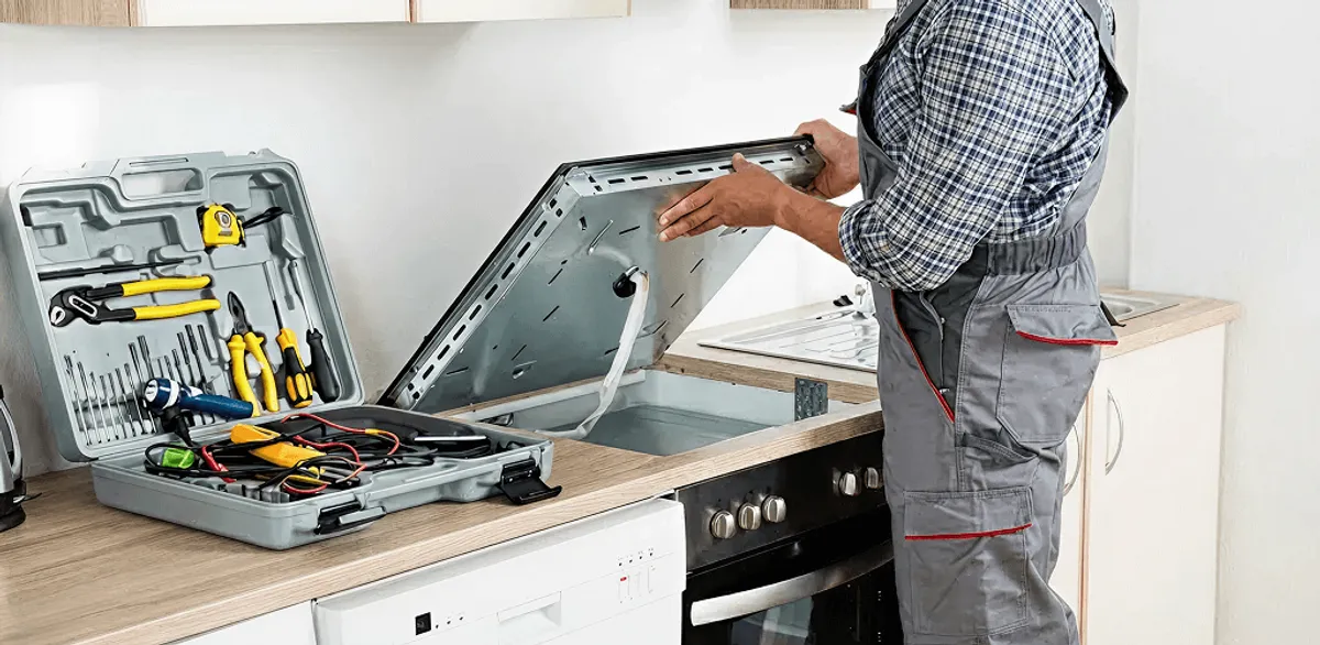 Handyman repairing a cooktop and checking wiring connections in Provo, UT
