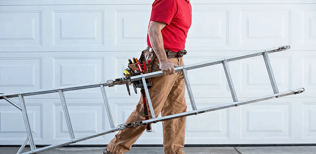 Garage door repair technician arriving with tools and ladder in Provo, UT