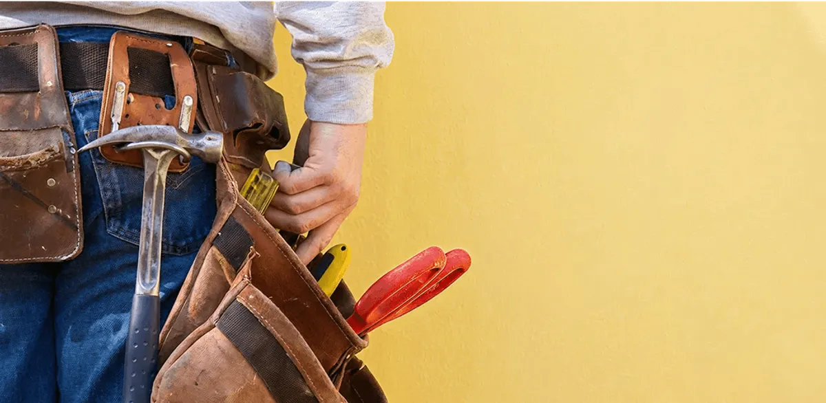 Handyman with tool belt ready for home repairs and maintenance in Provo, UT