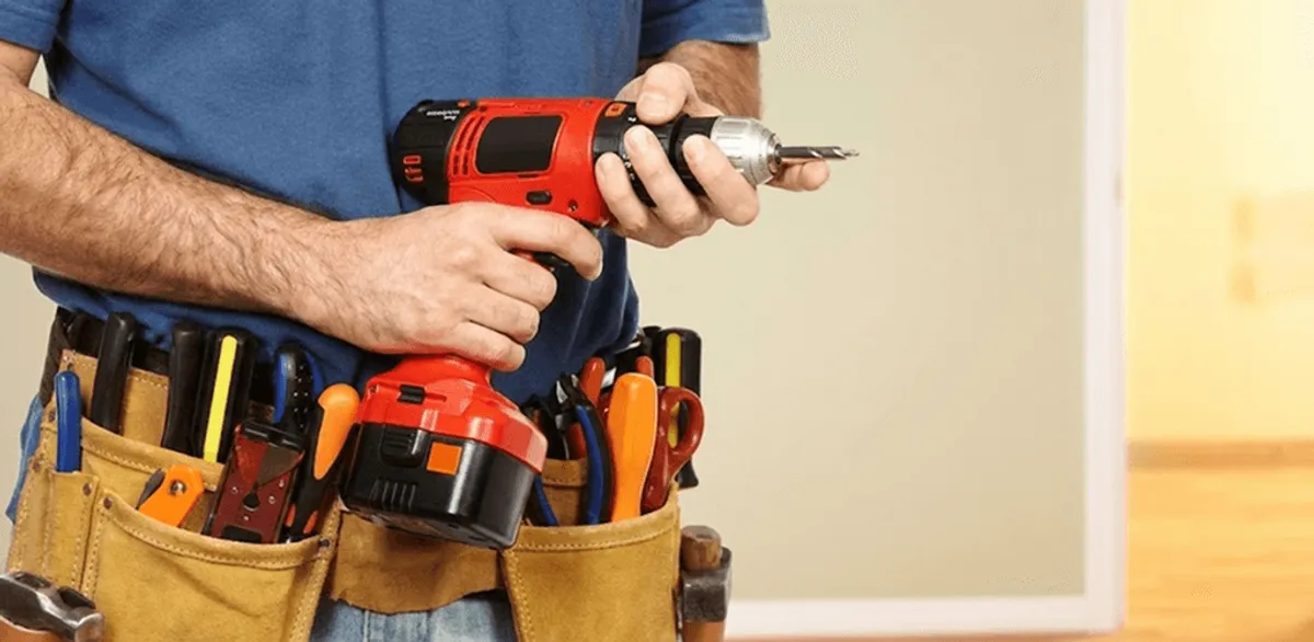 Handyman holding a power drill for home repairs and installations in Provo, UT
